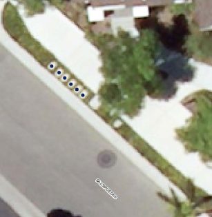 Aerial view of a house and streetDescription automatically generated