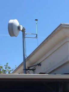 A satellite dish on top of a buildingDescription automatically generated